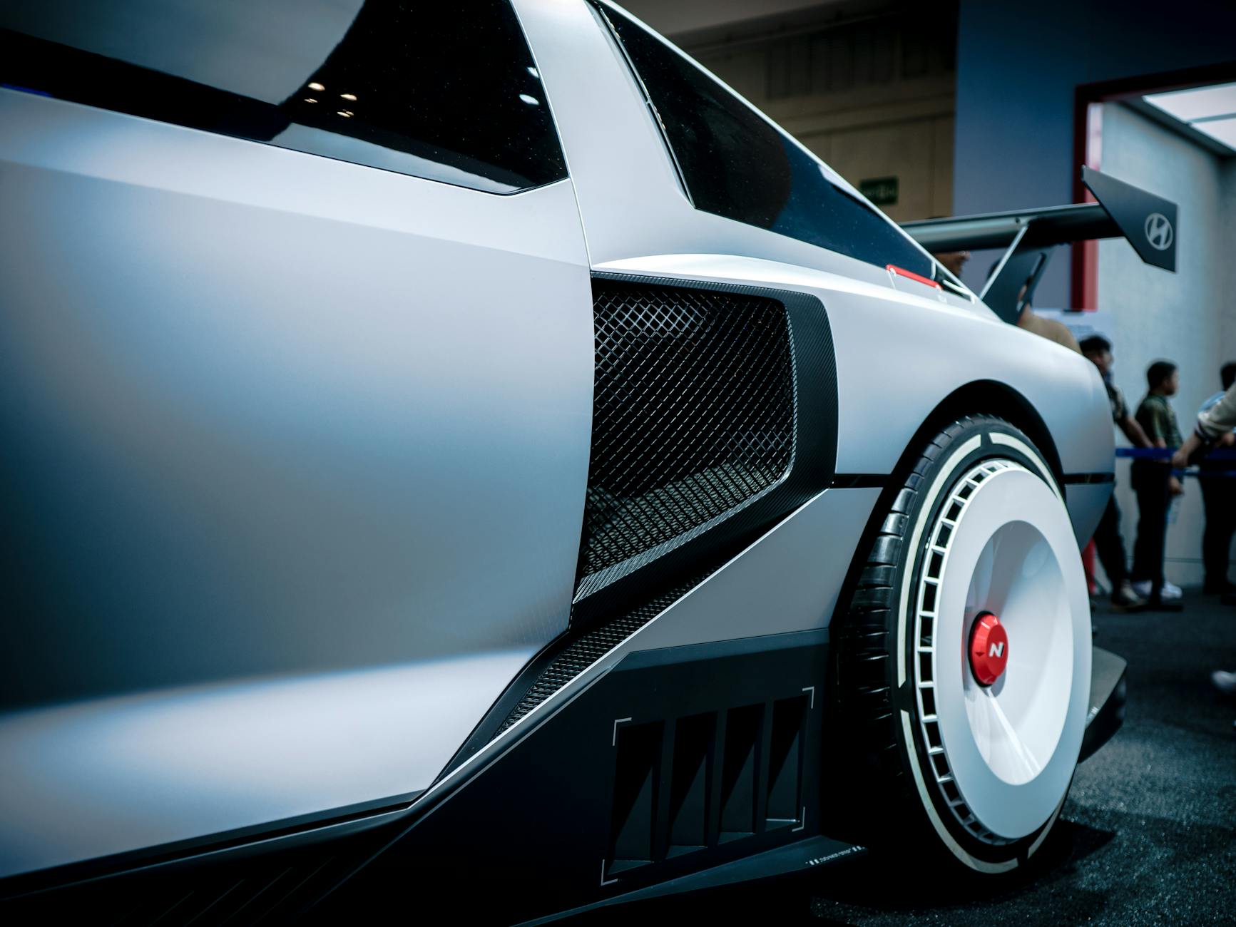 Ilustrasi: Close-up of a Hyundai concept car showcased in an indoor exhibition with modern design details.