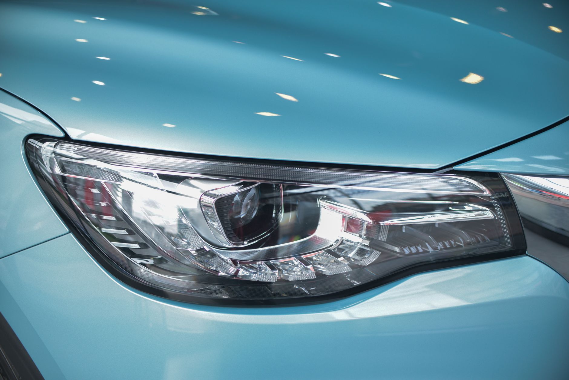 Ilustrasi: Detailed close-up of a modern car's headlight with a sleek design.