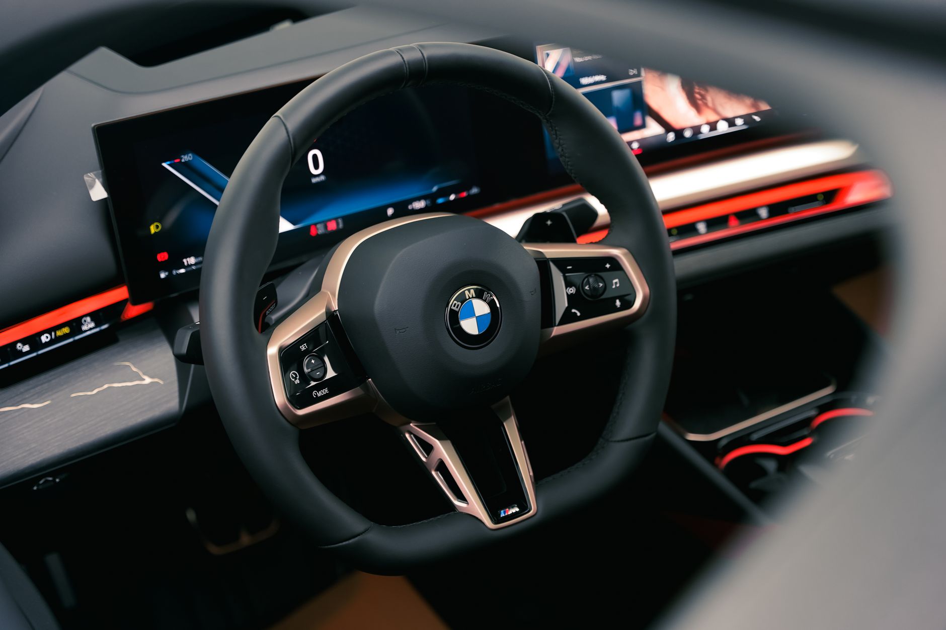 Ilustrasi: Close-up of a modern car's sleek steering wheel and dashboard design.